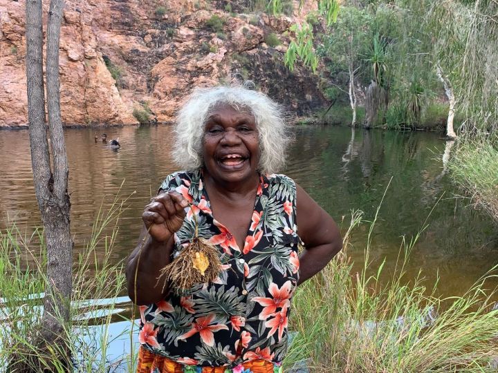 Aboriginal Artist Agnes with cheeky yam.jpg